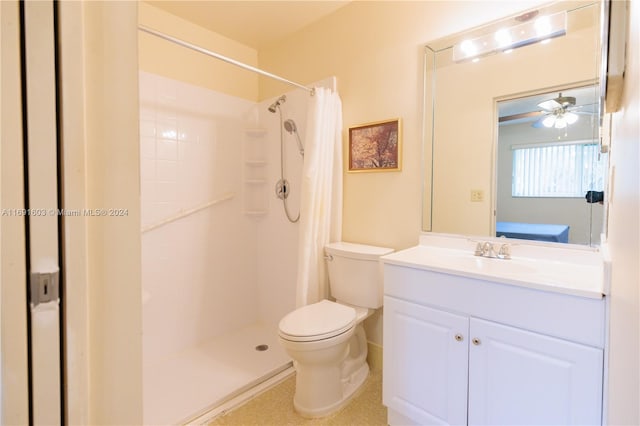 bathroom with a shower with shower curtain, vanity, toilet, and ceiling fan