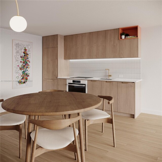 dining area with light hardwood / wood-style floors and sink