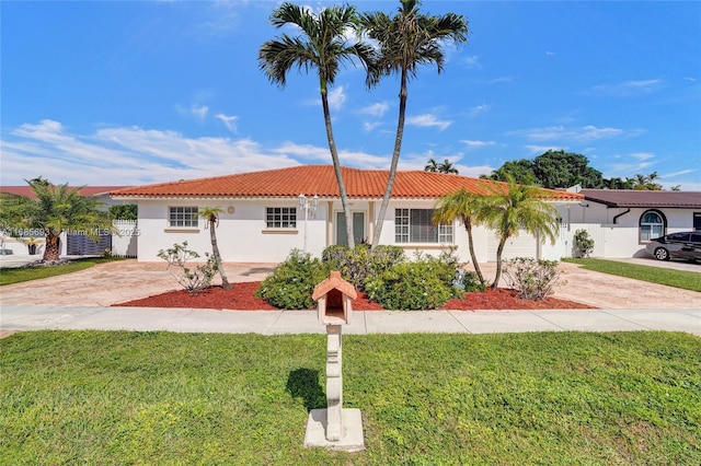 mediterranean / spanish-style home with a front lawn