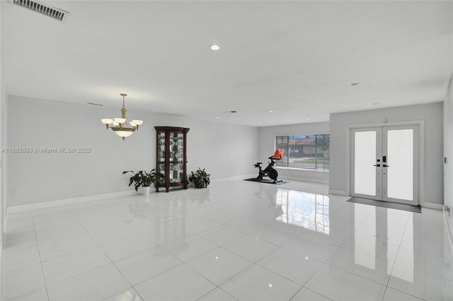 8925 SW 11th St, Miami, FL 33174 - empty room featuring a chandelier, light tile patterned flooring, recessed lighting, baseboards, and french doors