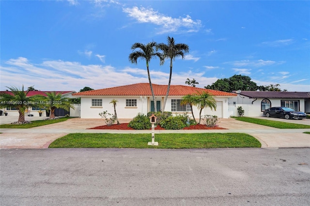 view of front facade with a garage and a front lawn