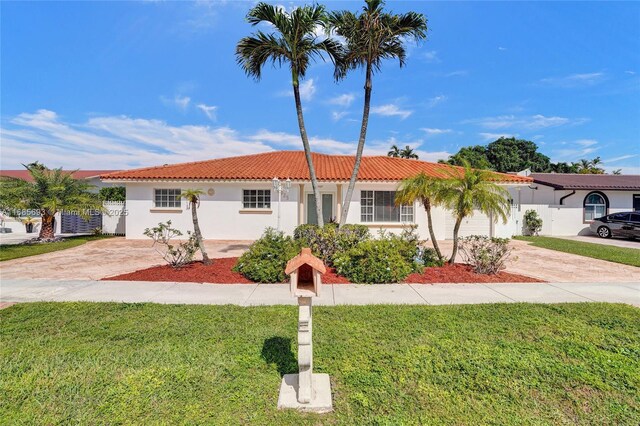 8925 SW 11th St, Miami, FL 33174 - view of front of property featuring driveway, a tiled roof, a front yard, and stucco siding