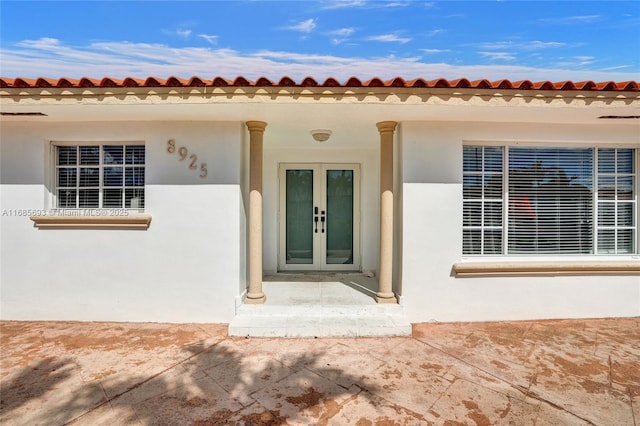 entrance to property featuring a patio area and french doors