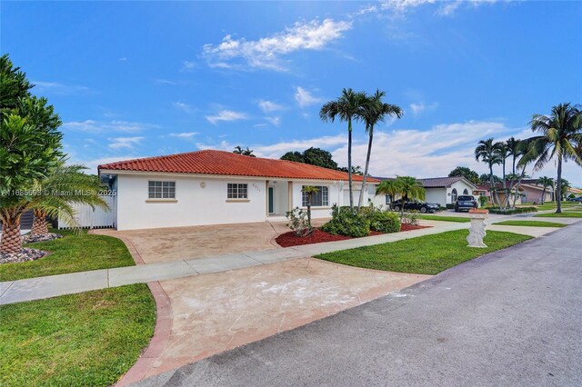 8925 SW 11th St, Miami, FL 33174 - view of front of property with driveway, stucco siding, a tile roof, and a front yard