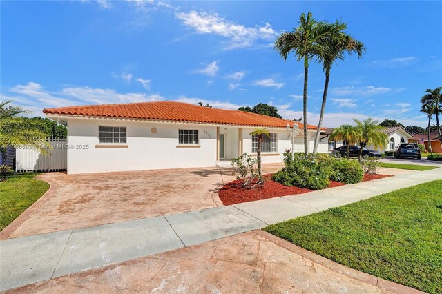 8925 SW 11th St, Miami, FL 33174 - mediterranean / spanish-style home featuring stucco siding, driveway, a tile roof, and fence