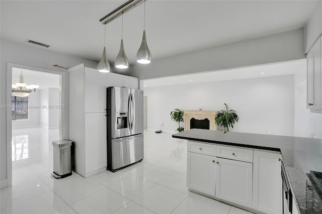 kitchen with decorative light fixtures, white cabinetry, dark stone countertops, a chandelier, and stainless steel fridge with ice dispenser