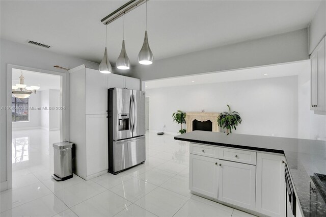 8925 SW 11th St, Miami, FL 33174 - kitchen featuring stainless steel fridge, a peninsula, white cabinetry, and a chandelier