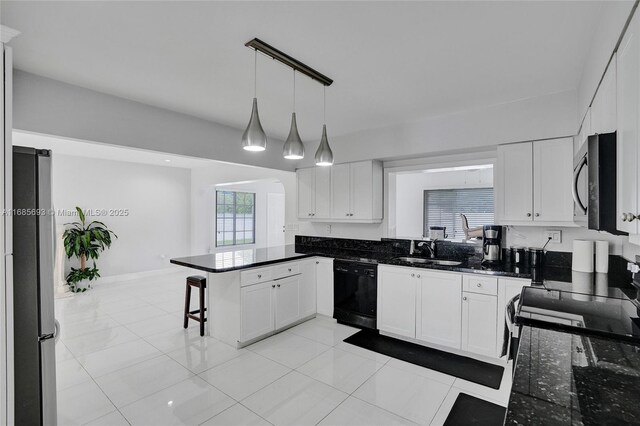 8925 SW 11th St, Miami, FL 33174 - kitchen with black appliances, a sink, a peninsula, a breakfast bar area, and white cabinetry