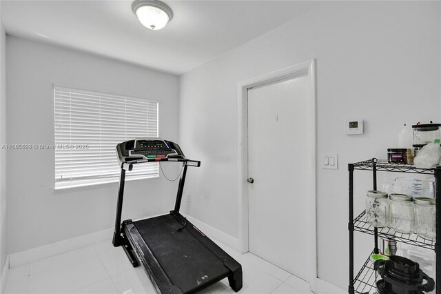 exercise room featuring light tile patterned flooring