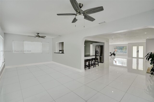 8925 SW 11th St, Miami, FL 33174 - spare room with light tile patterned floors, arched walkways, baseboards, french doors, and recessed lighting