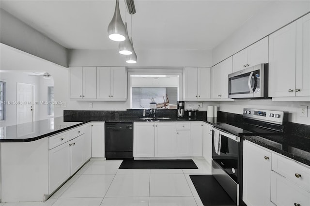 kitchen featuring hanging light fixtures, appliances with stainless steel finishes, and white cabinets