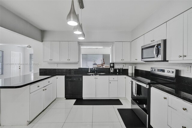 8925 SW 11th St, Miami, FL 33174 - kitchen with appliances with stainless steel finishes, a peninsula, white cabinets, and light tile patterned floors