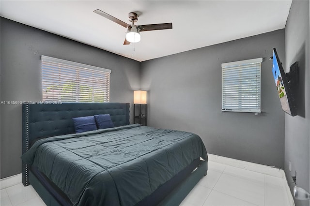 tiled bedroom featuring ceiling fan