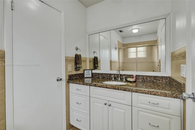 bathroom with vanity and an enclosed shower