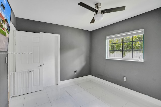 unfurnished bedroom with light tile patterned flooring and ceiling fan