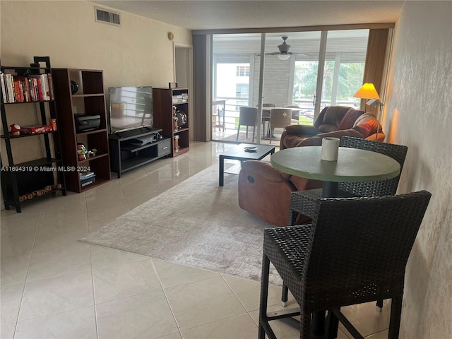 living room featuring ceiling fan, a healthy amount of sunlight, and light tile patterned floors