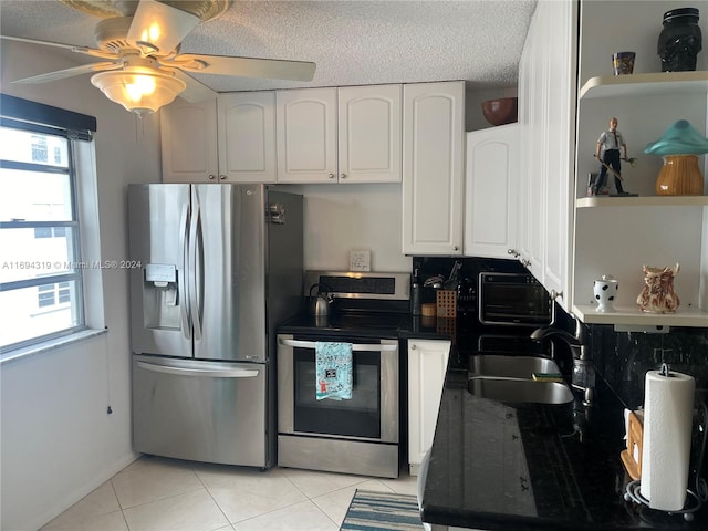 kitchen featuring ceiling fan, sink, light tile patterned floors, white cabinets, and appliances with stainless steel finishes