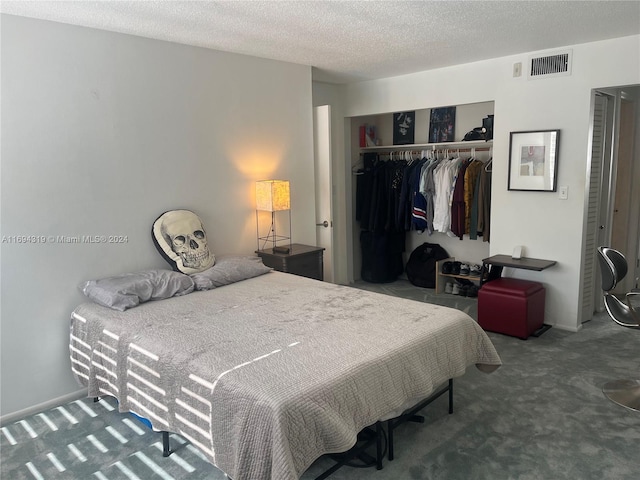 carpeted bedroom with a closet and a textured ceiling