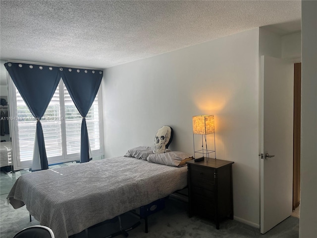 bedroom featuring carpet and a textured ceiling