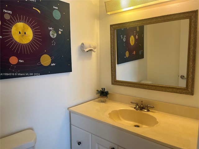 bathroom with vanity and toilet