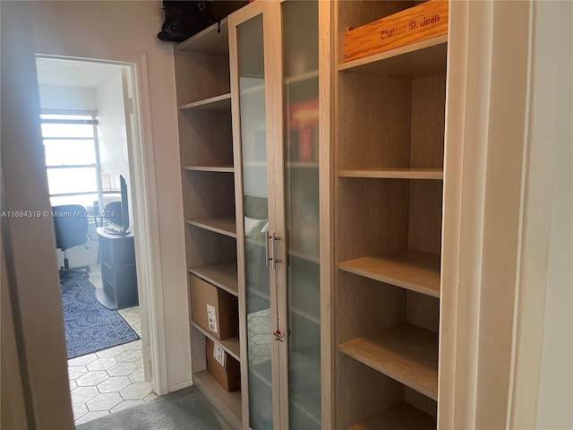 walk in closet with tile patterned flooring