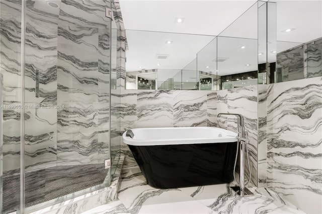 bathroom with plus walk in shower and tile walls