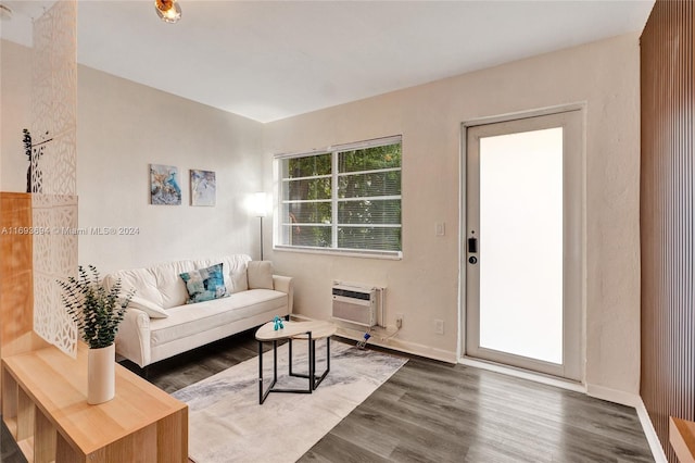 living room with dark hardwood / wood-style floors and an AC wall unit