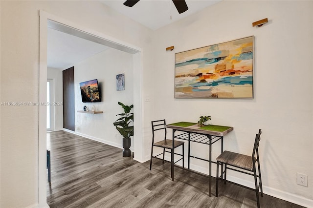 dining space with hardwood / wood-style floors and ceiling fan