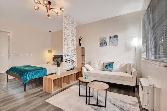 living room with hardwood / wood-style floors and a notable chandelier