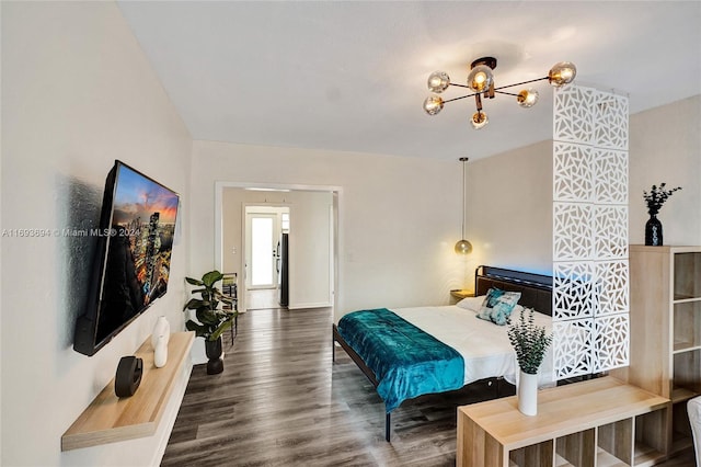 bedroom with an inviting chandelier and dark wood-type flooring