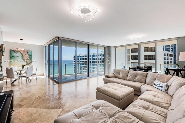 living room featuring a water view and floor to ceiling windows