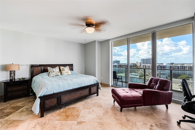 bedroom with access to outside, multiple windows, ceiling fan, and expansive windows