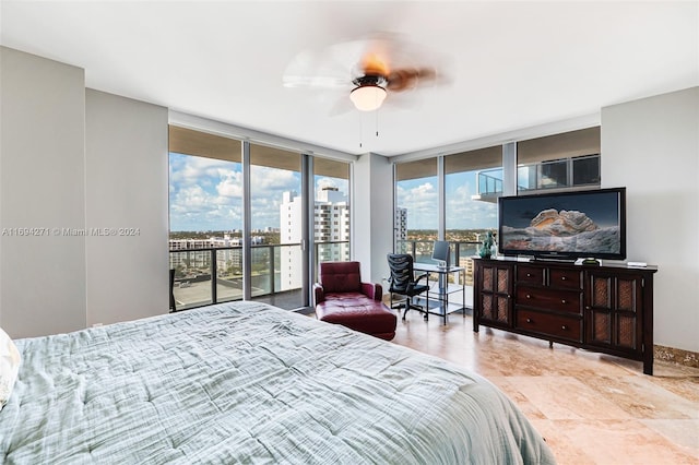 bedroom with access to outside, expansive windows, and ceiling fan