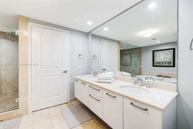 bathroom with tile patterned flooring, vanity, and independent shower and bath