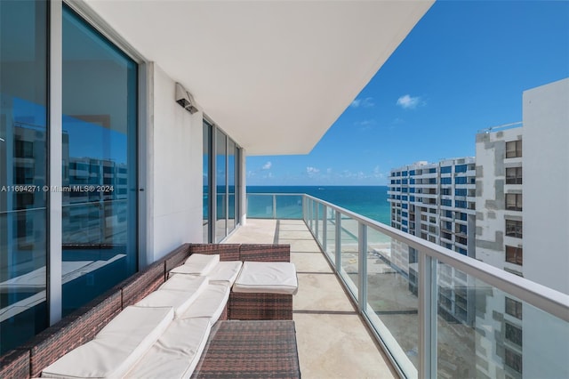 balcony with an outdoor hangout area and a water view