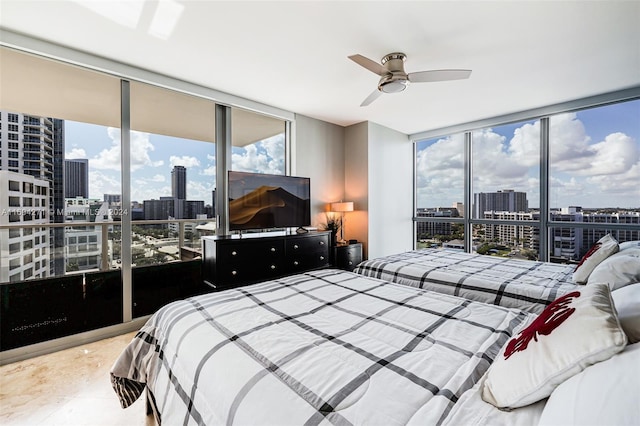 bedroom with ceiling fan and a wall of windows