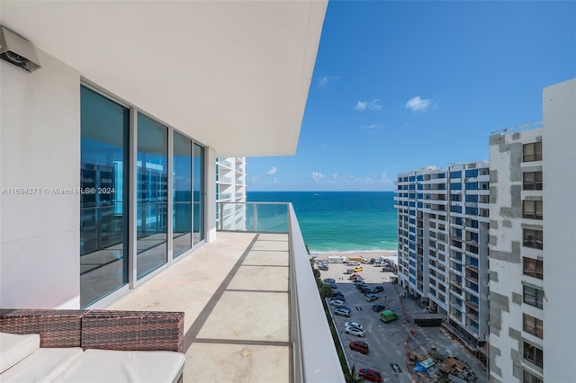 balcony with a water view and a beach view