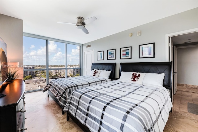 bedroom featuring expansive windows and ceiling fan