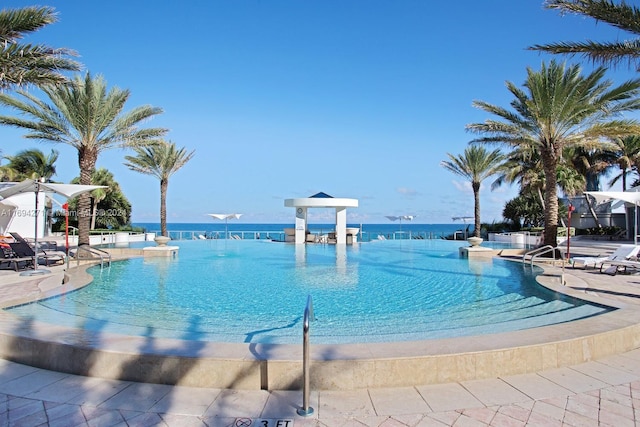 view of swimming pool featuring a water view