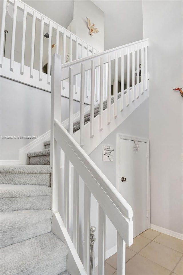 stairs featuring tile patterned floors