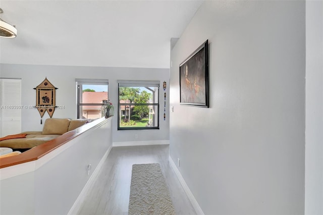 hallway with light hardwood / wood-style floors