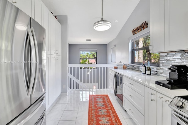 kitchen featuring white cabinetry, plenty of natural light, decorative light fixtures, and appliances with stainless steel finishes