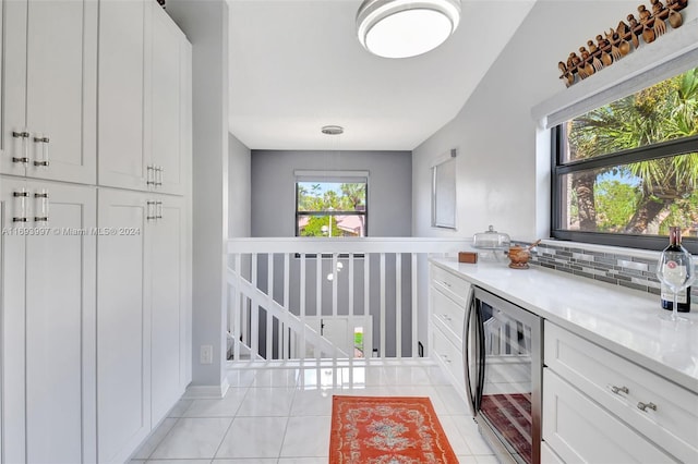 interior space with wine cooler and light tile patterned flooring