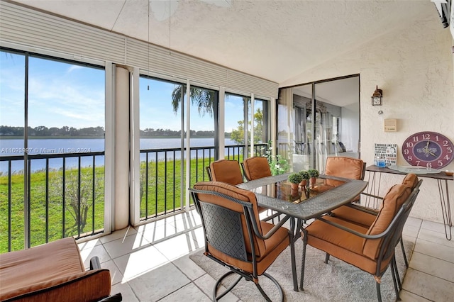 sunroom / solarium featuring plenty of natural light, a water view, and lofted ceiling