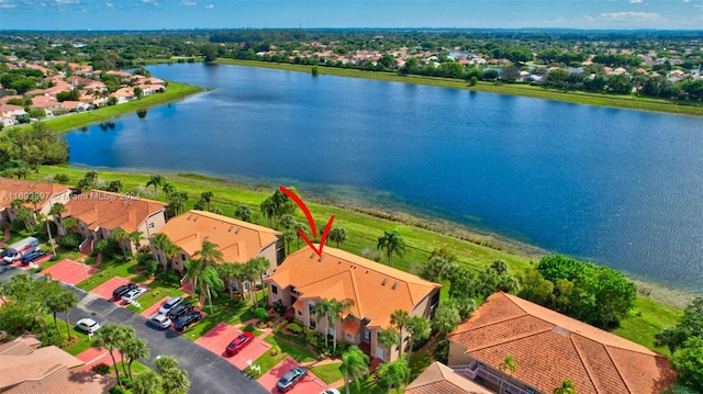 birds eye view of property with a water view