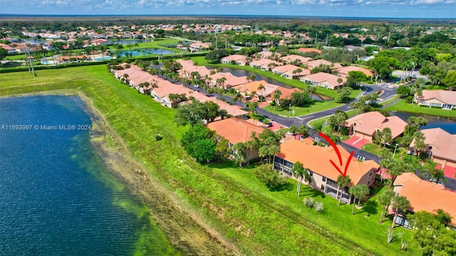 birds eye view of property with a water view