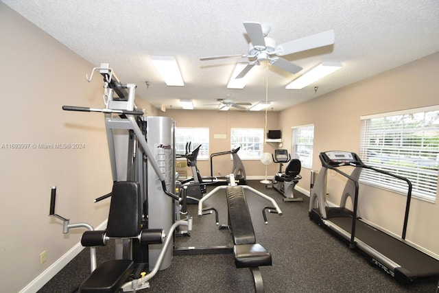 exercise room featuring a textured ceiling and ceiling fan