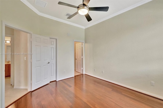 unfurnished bedroom with ceiling fan, light wood-type flooring, and ornamental molding