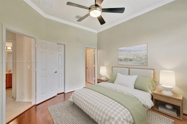 bedroom with light wood-type flooring, ceiling fan, and ornamental molding