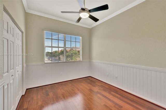 unfurnished room featuring wood-type flooring, ceiling fan, and ornamental molding